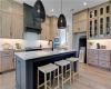 Custom cabinetry and a generous center island define this beautifully crafted kitchen space.