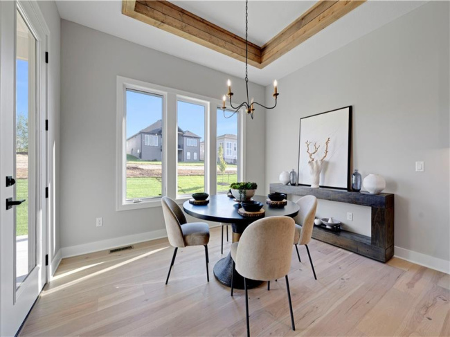 Gleaming hardwood floors and a statement tray ceiling define this elegant dining space.