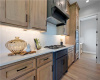 Natural wood cabinetry and custom solid surface countertops define this modern cooking space.