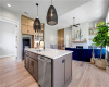 An open floorplan seamlessly connects the island kitchen to a bright living area.