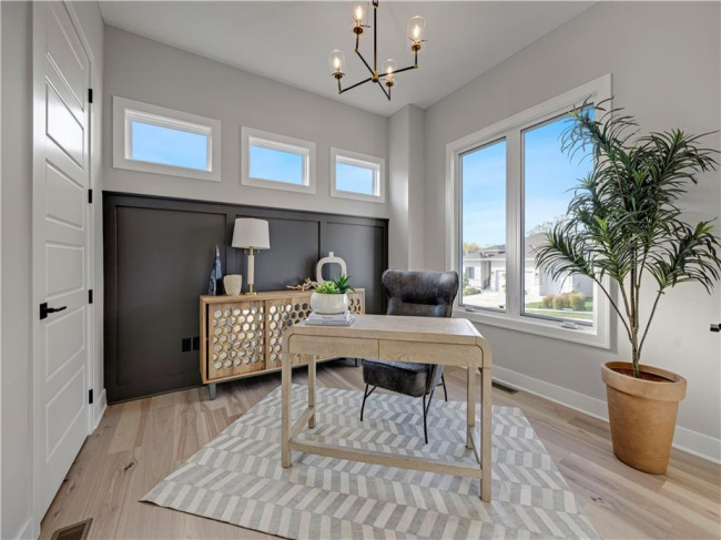 Gleaming hardwood floors and a modern light fixture elevate this quiet home office space.