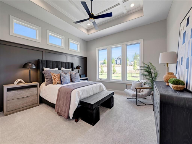 High coffered ceilings and generous windows define this elegant bedroom retreat.