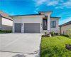 Clean lines and a spacious driveway define this modern single-level residence.