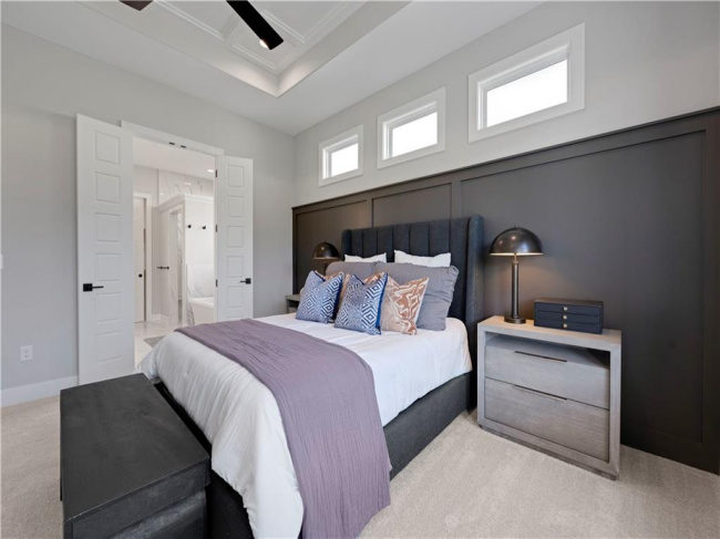 Inlaid wall paneling and clerestory windows highlight this serene master bedroom.