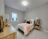 Soft carpeting pairs with neutral walls and a deep-silled window in this cozy bedroom.