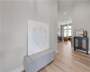 Clean lines and warm hardwood floors create an inviting entryway leading to the main living space.