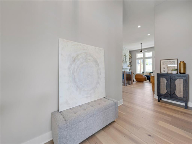 Clean lines and warm hardwood floors create an inviting entryway leading to the main living space.