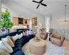 Hardwood floors and soaring ceilings define this airy, open-concept living space connected to the kitchen.