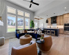 An open floor plan connects the light-filled living area to a modern kitchen.